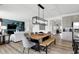 Open-concept dining area features a modern light fixture, stylish seating, and adjacent living spaces at 1067 Marston Ln, Avon, IN 46123