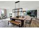 Open-concept dining area flows into the living area, showcasing a modern table and stylish decor at 1067 Marston Ln, Avon, IN 46123