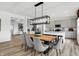 Bright dining area features modern light fixture, stylish seating, and an open layout to the kitchen at 1067 Marston Ln, Avon, IN 46123
