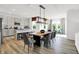 Bright dining area features modern light fixture and seating, connecting to the open kitchen space at 1067 Marston Ln, Avon, IN 46123