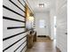 Inviting entryway with wood-look floors, modern lighting, and a stylish accent wall with decor at 1067 Marston Ln, Avon, IN 46123