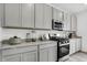 Close-up on a kitchen with stainless steel appliances, gray cabinets and countertops at 1067 Marston Ln, Avon, IN 46123