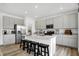 Bright kitchen features gray cabinetry, stainless steel appliances and a center island with bar stool seating at 1067 Marston Ln, Avon, IN 46123