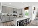 Kitchen features gray cabinets, stainless appliances, a kitchen island with seating, and a window with natural light at 1067 Marston Ln, Avon, IN 46123