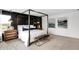 Spacious main bedroom with a four-poster bed, stylish accents, and large windows at 1067 Marston Ln, Avon, IN 46123