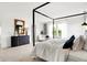 Bright main bedroom featuring a four-poster bed, dresser, and views to the neighborhood at 1067 Marston Ln, Avon, IN 46123