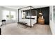 Elegant main bedroom with a four-poster bed, paneled accent wall, and ample natural light at 1067 Marston Ln, Avon, IN 46123