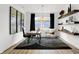 Stylish home office with a modern desk, accent chair, geometric rug, and floating shelves at 1067 Marston Ln, Avon, IN 46123