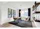 Bright home office featuring a modern desk, floating shelves and geometric area rug at 1067 Marston Ln, Avon, IN 46123