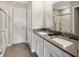 Bright bathroom featuring a double vanity with gray countertop and a glass door shower at 1075 Marston Ln, Avon, IN 46123