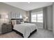 Inviting bedroom features neutral walls, a comfortable bed with decorative pillows, and natural light from a large window at 1075 Marston Ln, Avon, IN 46123