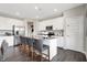 Bright kitchen featuring an island with barstool seating, stainless steel appliances, and white cabinetry at 1075 Marston Ln, Avon, IN 46123