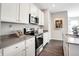 Well-equipped kitchen featuring stainless steel appliances, white cabinetry, and durable countertops at 1075 Marston Ln, Avon, IN 46123
