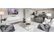 Open concept living room with eat-in kitchen, tv, staircase, and modern decor in a neutrally painted space at 1075 Marston Ln, Avon, IN 46123