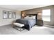 Serene main bedroom featuring a wood-look wall, plush carpet, and natural light at 1075 Marston Ln, Avon, IN 46123