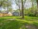 Lush backyard with a mix of green grass and mature trees, enhancing the property's natural appeal at 1132 Sharon Ave, Indianapolis, IN 46222