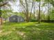 Green backyard featuring mature trees and a well-maintained lawn, perfect for outdoor enjoyment and relaxation at 1132 Sharon Ave, Indianapolis, IN 46222