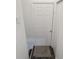Basement stairway with gray wood-look flooring and white door at 1132 Sharon Ave, Indianapolis, IN 46222