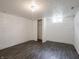 Finished basement room with gray wood-look floor and closet at 1132 Sharon Ave, Indianapolis, IN 46222