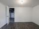 Unfinished basement area with durable gray flooring, offering versatility for storage or future customization at 1132 Sharon Ave, Indianapolis, IN 46222