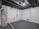 Unfinished basement with water heater and gray painted floor at 1132 Sharon Ave, Indianapolis, IN 46222