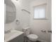 Bright bathroom with a gray vanity, rounded mirror, and white toilet at 1132 Sharon Ave, Indianapolis, IN 46222