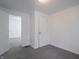 A bedroom with neutral walls, carpeted floors and an open doorway to another room at 1132 Sharon Ave, Indianapolis, IN 46222