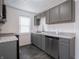 A kitchen with gray cabinets, stainless appliances, and light countertops at 1132 Sharon Ave, Indianapolis, IN 46222