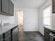Bright kitchen featuring gray cabinets, stainless steel dishwasher, and entry to the bathroom at 1132 Sharon Ave, Indianapolis, IN 46222