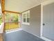 Close up of the covered porch, showcasing the wood beams and gray siding at 1132 Sharon Ave, Indianapolis, IN 46222