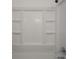 Clean white shower and tub combo with molded in shelving at 1132 Sharon Ave, Indianapolis, IN 46222
