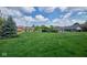 Expansive backyard lawn, swimming pool, and brick and siding home exteriors at 1142 Canterbury S Sq # B, Indianapolis, IN 46260