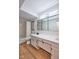 Bathroom with double sink vanity, modern lighting and hardwood flooring at 1142 Canterbury S Sq # B, Indianapolis, IN 46260