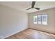 Bright bedroom with hardwood floors, ceiling fan, and a large window at 1142 Canterbury S Sq # B, Indianapolis, IN 46260