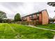 Brick exterior of home featuring a wooden fence, well-manicured lawn, and private balconies at 1142 Canterbury S Sq # B, Indianapolis, IN 46260