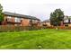 Exterior brick building complex with large lawn and wood fences separating units for privacy at 1142 Canterbury S Sq # B, Indianapolis, IN 46260