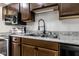 A close up of the stainless steel sink and light colored countertop in this modern kitchen at 1142 Canterbury S Sq # B, Indianapolis, IN 46260