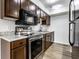 Kitchen with stainless steel appliances, warm wood cabinets and light countertops at 1142 Canterbury S Sq # B, Indianapolis, IN 46260