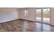 Bright living room with hardwood floors, windows and sliding doors leading to backyard at 1142 Canterbury S Sq # B, Indianapolis, IN 46260