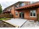 Rear patio with privacy fence, adjacent balcony, concrete patio, and small garden at 1142 Canterbury S Sq # B, Indianapolis, IN 46260