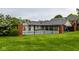Outdoor swimming pool surrounded by fencing, lush green grass, and trees at 1142 Canterbury S Sq # B, Indianapolis, IN 46260