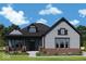 Charming two-story home with a shingle and brick exterior and inviting covered front porch at 11467 Selsey Rd, Fishers, IN 46040