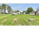 A sprawling grassy backyard features several outbuildings in various states of repair at 115 S Center St, Maxwell, IN 46154