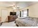 This is a bedroom showcasing a large dresser, TV, ceiling fan, and natural light at 115 S Center St, Maxwell, IN 46154