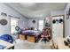 Spacious bedroom with a custom bedframe, windows for natural light and an orange gaming chair at 115 S Center St, Maxwell, IN 46154