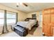 Cozy bedroom featuring a queen-sized bed with storage, natural light and a ceiling fan at 115 S Center St, Maxwell, IN 46154