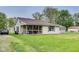 Cozy single-story home with a screened-in porch and a large, green front lawn at 115 S Center St, Maxwell, IN 46154