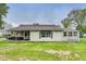 Charming single-story home featuring vinyl siding, a screened porch, and a well-maintained lawn at 115 S Center St, Maxwell, IN 46154