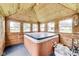 A hot tub room with an enclosed, cedar interior and several windows for natural lighting at 115 S Center St, Maxwell, IN 46154