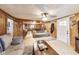 Inviting living room featuring wood paneled walls, stylish furnishings, and an open layout to the kitchen at 115 S Center St, Maxwell, IN 46154